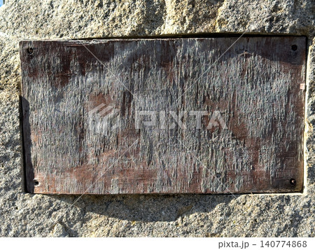 A weathered, rectangular wooden plaque, devoid of text 140774868