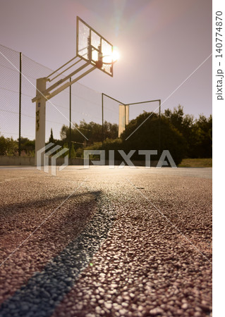 A ground-level view of a sun-drenched outdoor basketball court in Ovar 140774870
