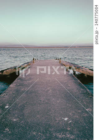 Concrete Pier Extending into the Calm Waters of Cais do Abrigo in Torreira Portugal 140775084