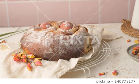 Traditional Portuguese Easter Sweet Bread Folar de Pascoa with Red Eggs on a White Wire Rack Traditional Portuguese Easter Sweet Bread Folar de Pascoa with Red Eggs on a White Wire Rack 140775177