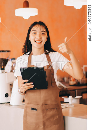 Young woman at barista school learning how to make espresso coffee. 140775541