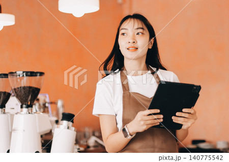 Young woman at barista school learning how to make espresso coffee. Young woman at barista school learning how to make espresso coffee. 140775542