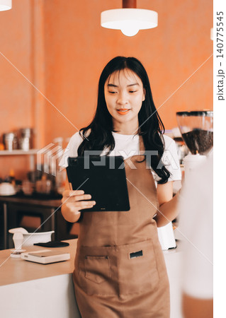 Young woman at barista school learning how to make espresso coffee. Young woman at barista school learning how to make espresso coffee. 140775545
