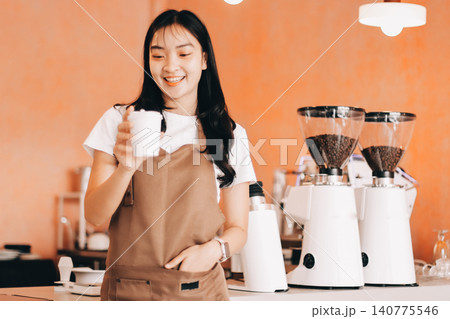 Young woman at barista school learning how to make espresso coffee. Young woman at barista school learning how to make espresso coffee. 140775546