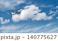 青空と白い雲をバックに飛行する日本航空(JAL)のエアバスA350型旅客機 140775627