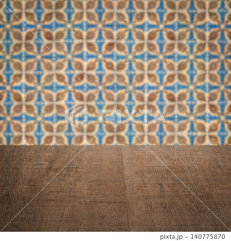 Wood table top and blur vintage ceramic tile pattern wall Wood table top and blur vintage ceramic tile pattern wall 140775870