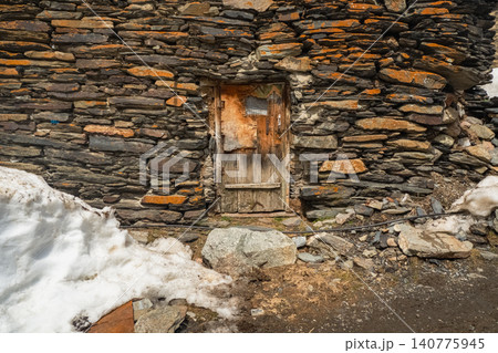 A weathered wooden door, likely a stock image of a village house 140775945