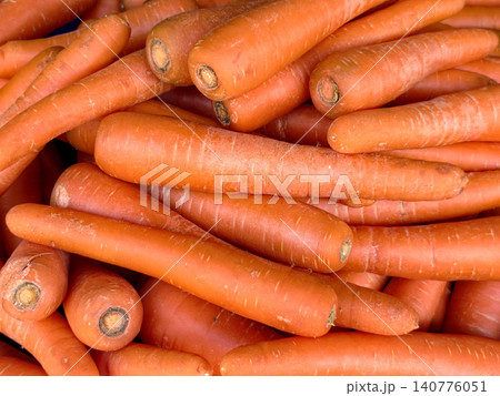Close-up of fresh raw orange carrots stacked together Close-up of fresh raw orange carrots stacked together 140776051