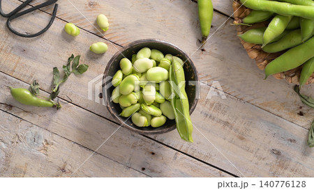 Fresh and raw green broad beans Fresh and raw green broad beans 140776128
