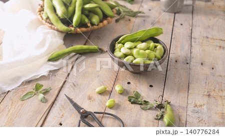 Fresh and raw green broad beans Fresh and raw green broad beans 140776284