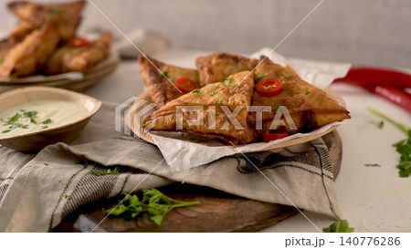 Crispy samosas with a side of sauce Crispy samosas with a side of sauce 140776286