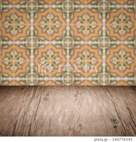 Wood table top and blur vintage ceramic tile pattern wall Wood table top and blur vintage ceramic tile pattern wall 140776595