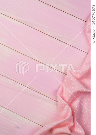 Pink towel over wooden table 140776678