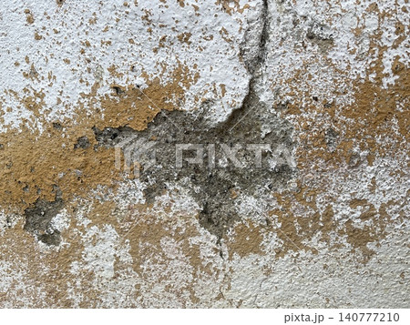 Damaged Wall with Cracks and Peeling Layers 140777210