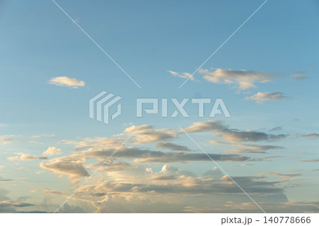 Soft white clouds floating horizontally in bright blue sky. Soft white clouds floating horizontally in bright blue sky. 140778666