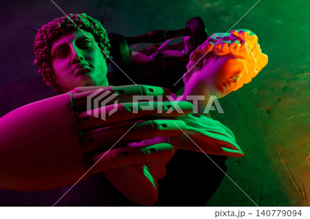 Multiple classical sculpture busts with vibrant neon gradient lighting in creative composition Multiple classical sculpture busts with vibrant neon gradient lighting in creative composition 140779094