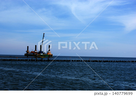 Polish Baltic Sea beautiful blue sea waves sand and beach drilling platform oil rig Polish Baltic Sea beautiful blue sea waves sand and beach drilling platform oil rig 140779699
