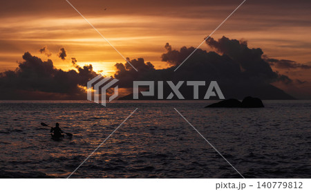 A vivid sunset paints the sky in orange and gold. Seychelles A vivid sunset paints the sky in orange and gold. Seychelles 140779812