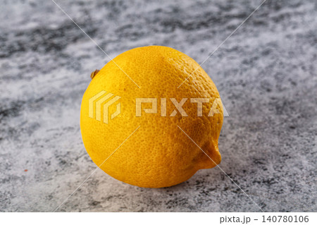 Fresh yellow lemon on textured gray surface Fresh yellow lemon on textured gray surface 140780106