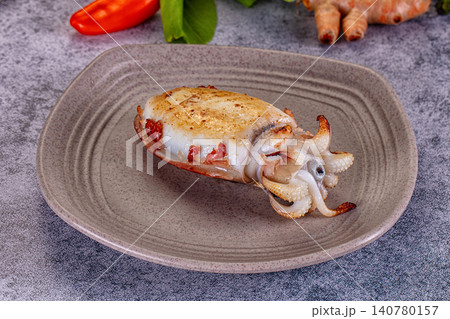 Grilled cuttlefish on ceramic plate with red pepper and turmeric Grilled cuttlefish on ceramic plate with red pepper and turmeric 140780157