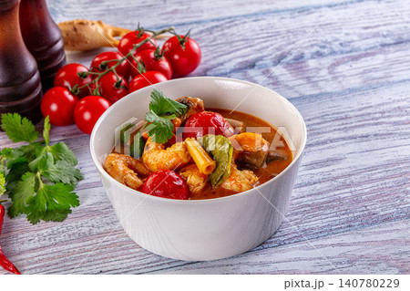 Spicy shrimp curry with cherry tomatoes and cilantro in white bowl Spicy shrimp curry with cherry tomatoes and cilantro in white bowl 140780229