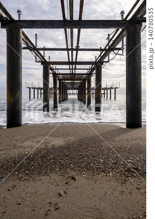Vintage Beach Pier Extending into the Sea. Vintage Beach Pier Extending into the Sea. 140780535