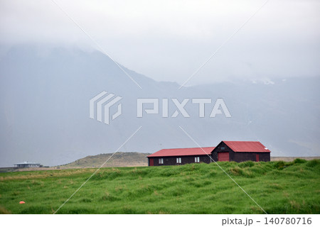 Icelandic farmhouses under misty mountains Icelandic farmhouses under misty mountains 140780716