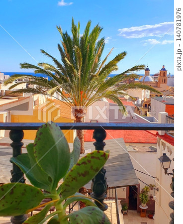 Scenic balcony view over the historic old town of Alicante with palm tree and sea background Scenic balcony view over the historic old town of Alicante with palm tree and sea background 140781976