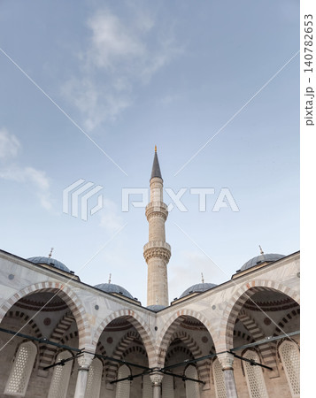 Islamic mosque courtyard with tall minaret and arches Islamic mosque courtyard with tall minaret and arches 140782653