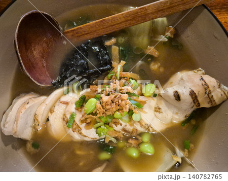 Grilled chicken noodle soup with herbs and broth 140782765