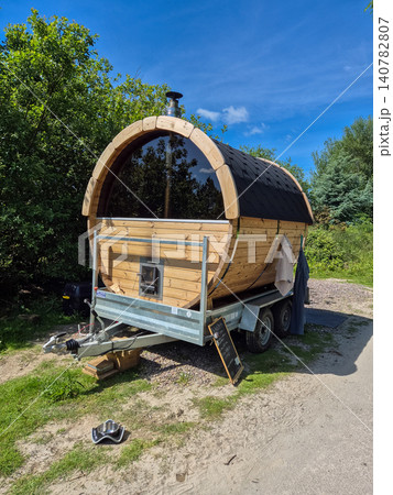 Wooden barrel sauna on trailer outdoors Wooden barrel sauna on trailer outdoors 140782807