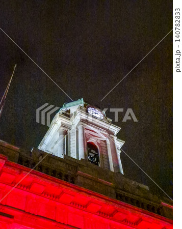 Illuminated historic clock tower at night Illuminated historic clock tower at night 140782833
