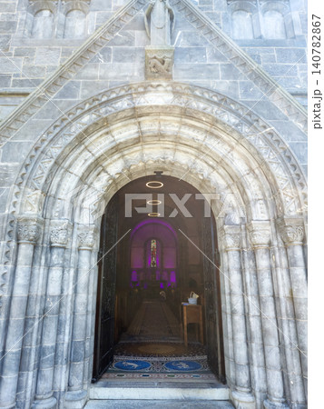 Ornate stone church entrance with arched doorway 140782867