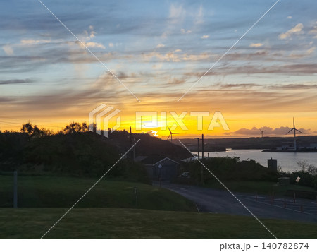 Sunset over coastal landscape with wind turbines 140782874