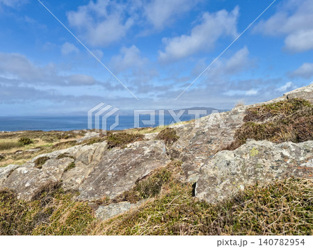 Rocky coastal landscape under blue cloudy sky 140782954