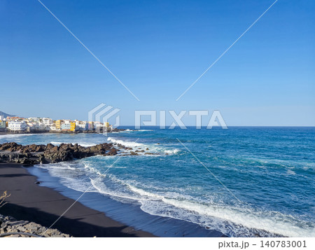 Coastal shoreline with black sand beach and ocean waves Coastal shoreline with black sand beach and ocean waves 140783001