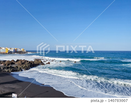 Rocky coastline with waves and seaside town Rocky coastline with waves and seaside town 140783007