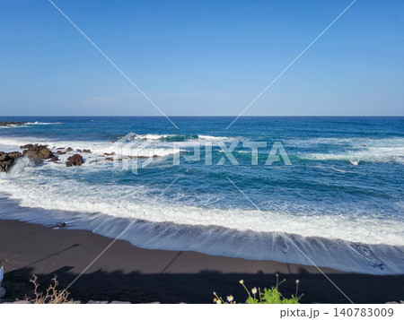 Rocky ocean shoreline with waves and blue sky Rocky ocean shoreline with waves and blue sky 140783009