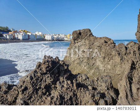 Rocky coastline with seaside town and waves Rocky coastline with seaside town and waves 140783011
