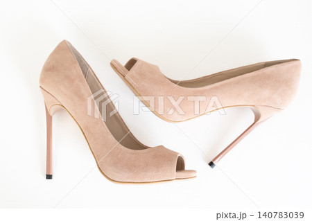 Nude peep toe high heel pumps isolated on white background Nude peep toe high heel pumps isolated on white background 140783039