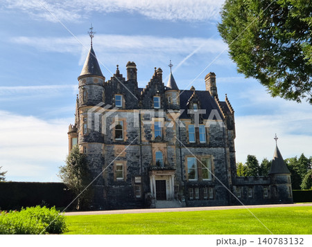 Historic stone castle with turrets and manicured grounds 140783132
