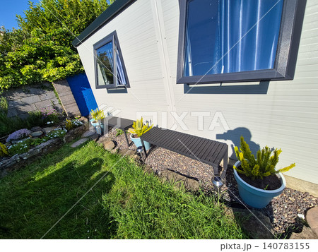Modern garden shed exterior with potted plants Modern garden shed exterior with potted plants 140783155