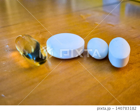 Assorted pills on wooden table Assorted pills on wooden table 140783182