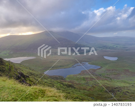 Mountain valley with lakes under dramatic cloudy sky 140783193