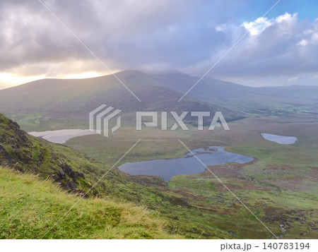 Mountain valley landscape with lakes and dramatic clouds Mountain valley landscape with lakes and dramatic clouds 140783194