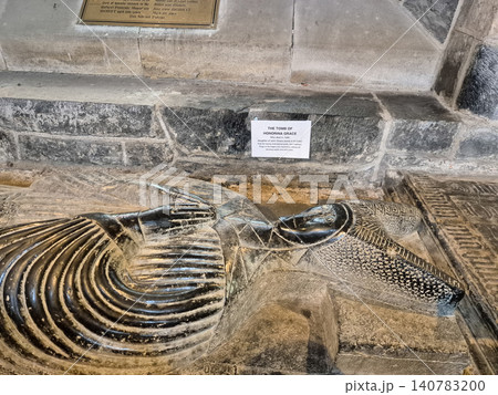 Historic stone tomb with carved effigy in cathedral interior 140783200