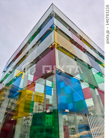 Colorful modern glass building facade seen from below Colorful modern glass building facade seen from below 140783216