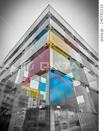 Modern glass building facade with colorful panels 140783218