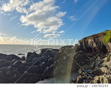 Rocky Coastal Cliffs Under Blue Sky Rocky Coastal Cliffs Under Blue Sky 140783243