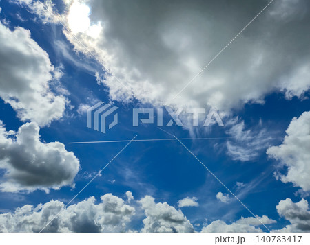 Bright blue sky with dramatic clouds and contrail Bright blue sky with dramatic clouds and contrail 140783417